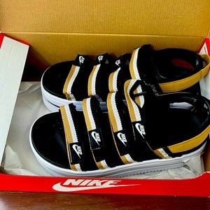 Woman’s Nike sandals. Size 10. Black, white, and gold.